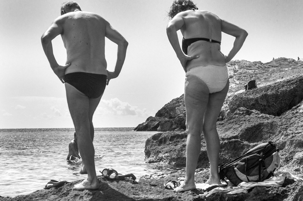 A photograph of an elderly couple on the beach in Puglia taken during a trip to mourn my father.