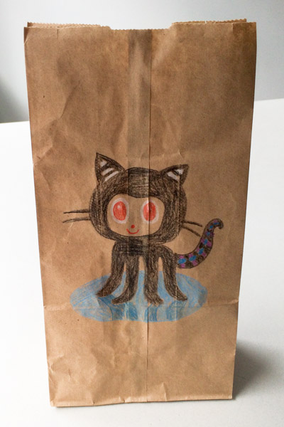 An octocat on a paper bag, colored pencil on brown paper bag.