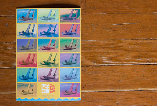 Mylius brochure back cover showing a series of repeating photographs of the 11E25 yacht with different tints, reminiscent of Andy Warhol's multiple-imagery work i.e. Marylin Monroe faces, flowers, cans of Campbell soup, etc.